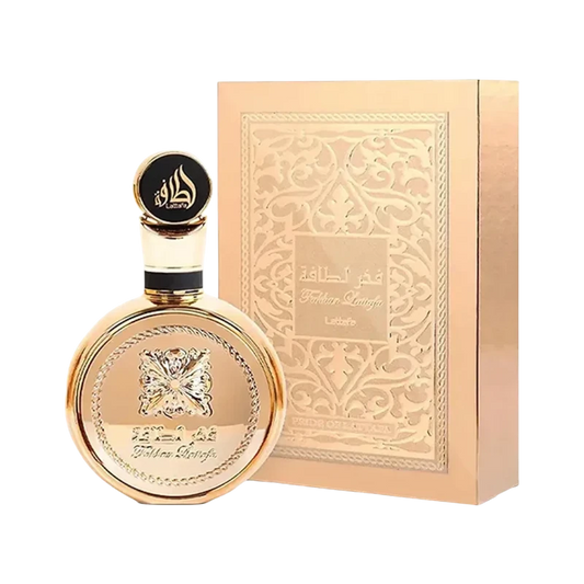 Perfume Fakhar Gold Extrait de BodegaPerfumera13 en frasco dorado circular con caja decorada a juego